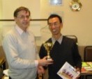 Lianpeng Zhang receives trophy from Tony Atkins